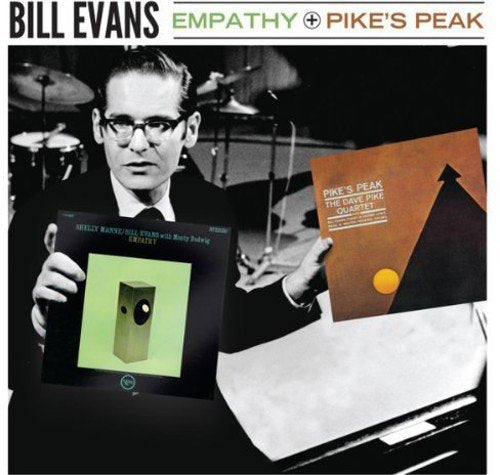 Bill Evans holding two album covers, Empathy and Pike's Peak, in a black and white photo.