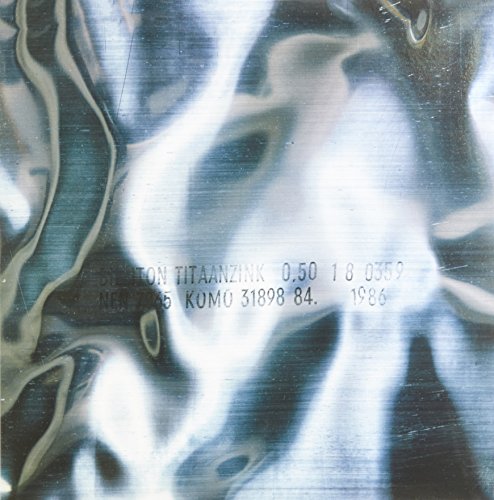 The image shows a close-up of a vinyl record with the text "VINYL 0.50" on it. Alt text: Vinyl record with "VINYL 0.50" text on a gray surface.