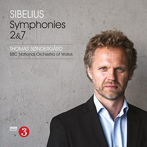 CD cover featuring a man in a suit against a grey background.