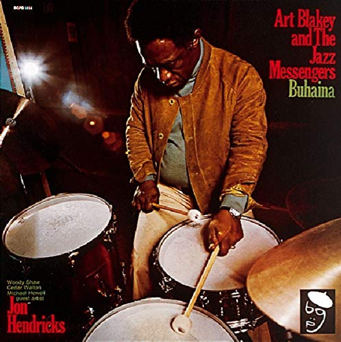 Vinyl record cover featuring a man playing drums with drumsticks, surrounded by cymbals.