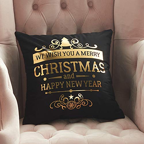 Black pillow with gold foil Christmas and New Year lettering.