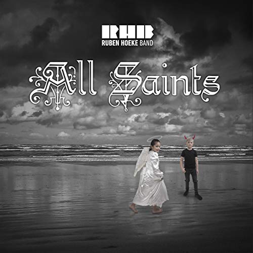 "Black and white album cover with two figures walking on a beach."