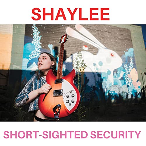 Shaylee album cover: woman with red guitar in front of mural.