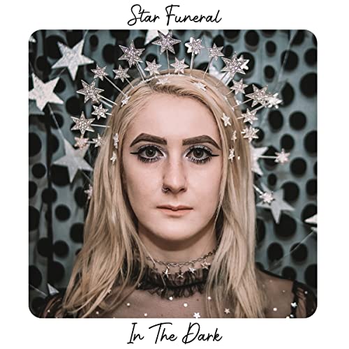 Album cover for Star Funeral’s “In The Dark” featuring a woman with star decorations.