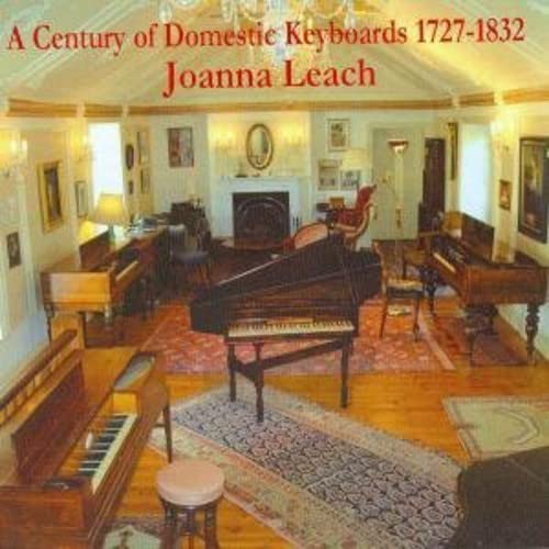 Interior room with several antique pianos and patterned rugs.