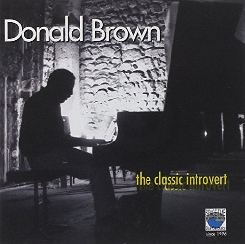 "Album cover with silhouette of man playing piano, white and yellow text, and a logo."