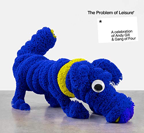 "Blue, fuzzy dog sculpture with yellow collar and large eye, on a grey surface."