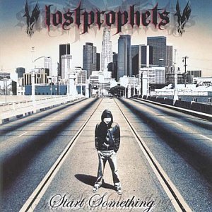 "Album cover with a man standing on train tracks, cityscape in the background."