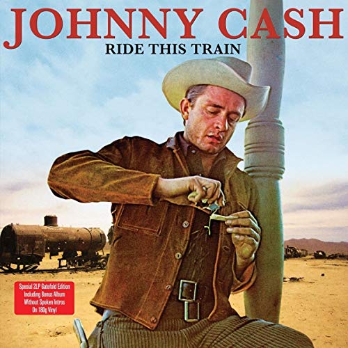 Johnny Cash in a cowboy hat working on a train engine.