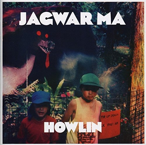 "Album cover with two boys and a large bear in a jungle."