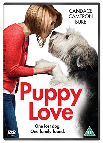DVD cover featuring a blonde woman kissing a large white and black dog.