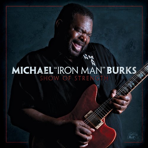 "Album cover featuring a man playing a red electric guitar, smiling."