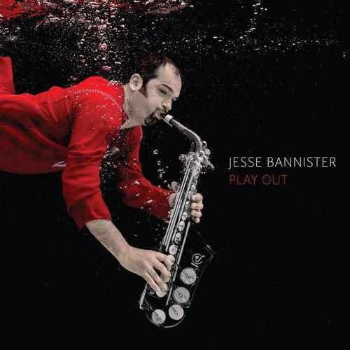 Man in red shirt plays saxophone underwater, surrounded by bubbles, on a black background.