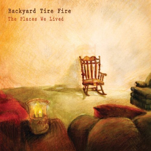 "Album cover art: dim room with a rocking chair and lit candle."