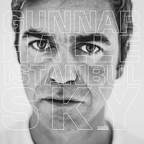 Black and white album cover with a man's face and large text overlay.