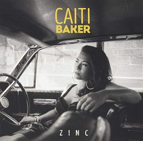 Black and white album cover featuring a woman sitting in a vintage car.