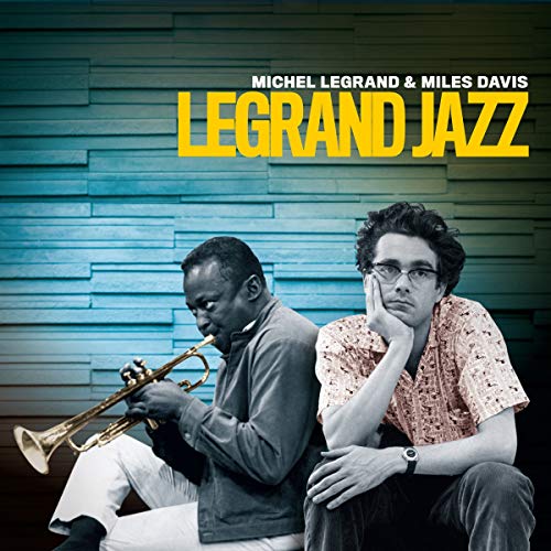 Miles Davis playing trumpet next to Michel Legrand against a blue textured background.