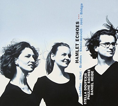 "CD cover featuring three musicians with flowing hair, black clothing, and a light background."