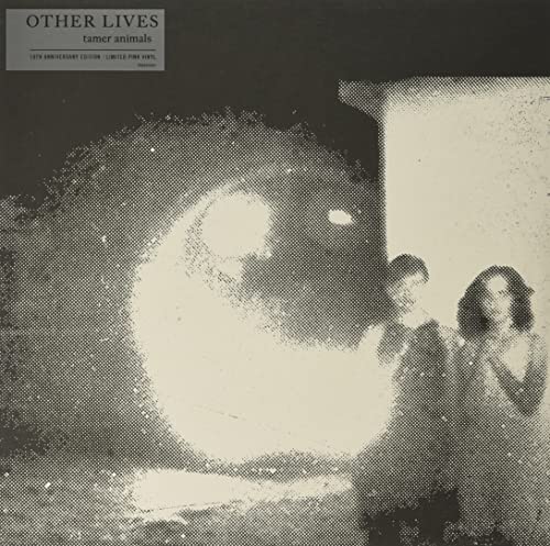 Grainy monochrome album cover featuring two figures beside a large, bright circular light.