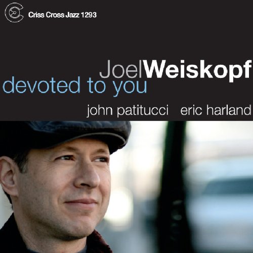 Album cover featuring a man wearing a cap, with text overlay.