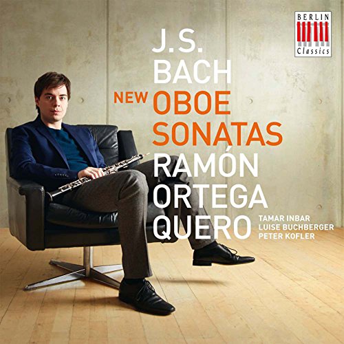 Man sitting in a chair holding an oboe, CD cover art.