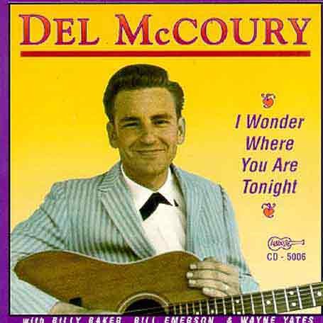 Del McCoury album cover featuring a man holding a guitar against a yellow background.