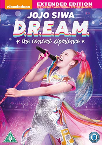 JoJo Siwa performing with a microphone, colorful outfit, and rainbow hair.