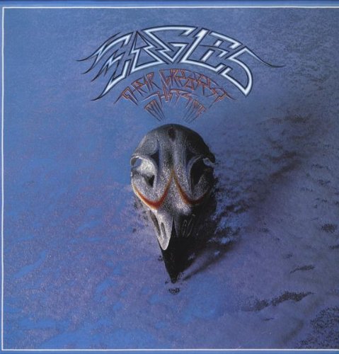 "Eagles vinyl album cover featuring a bird's head buried in sand against a blue background."
