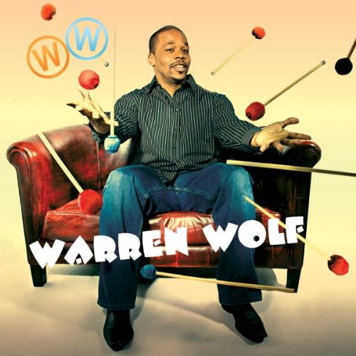 Man sitting on a red couch surrounded by mallets and mallets with mallets floating around him.