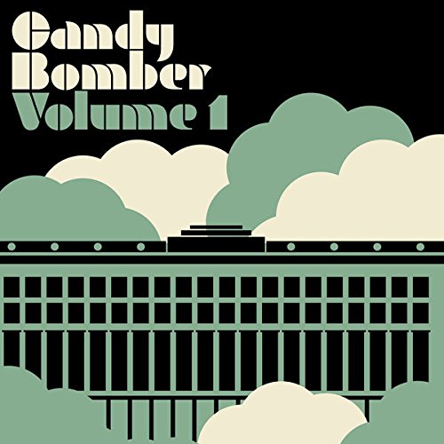 The image is a vinyl record cover with a black background, green and beige clouds, and a green and black building.
