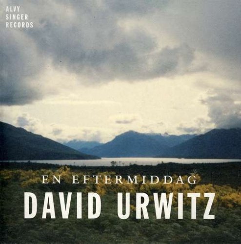 CD cover with a landscape of mountains, water, and cloudy sky.