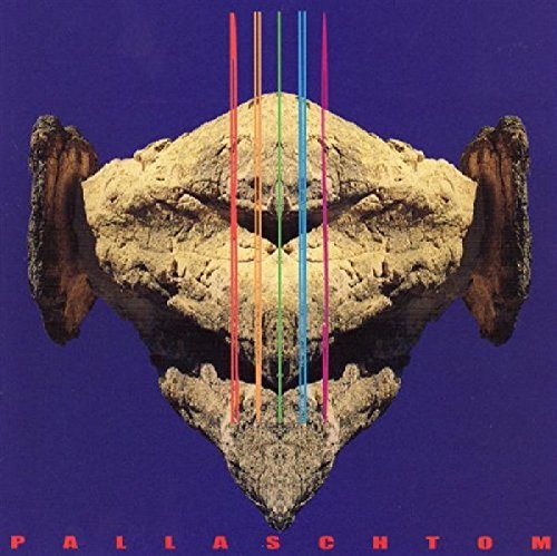 "Album cover featuring a stone face with colorful lines on a purple background."