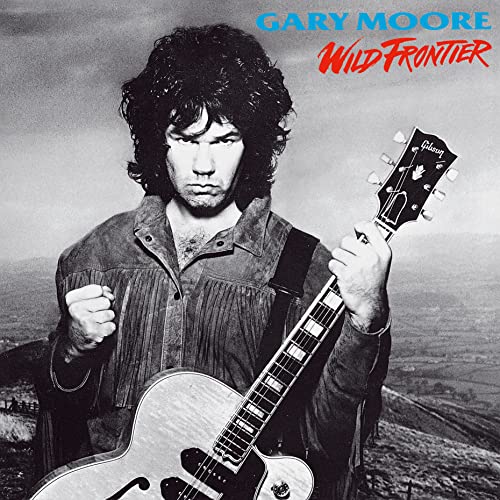 Gary Moore album cover, portrait of musician with guitar, landscape background.