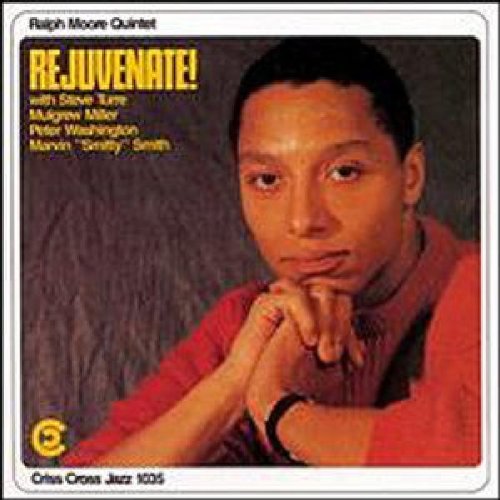 "Jazz CD cover featuring a man in a red sweater, contemplative pose."