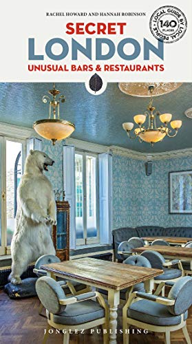 "Book cover showing a polar bear statue in a restaurant with wooden tables and chandeliers."