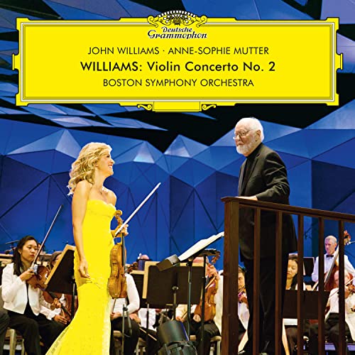 Violinist Anne-Sophie Mutter and composer John Williams with orchestra.
