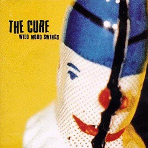 The Cure “Wild Mood Swings” CD cover, abstract face with yellow background.
