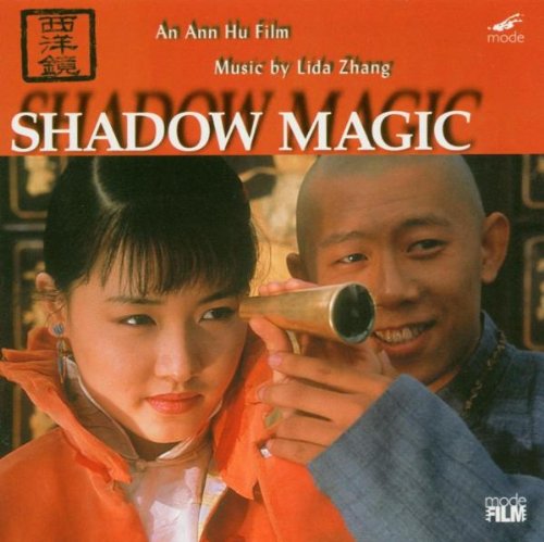 "Album cover for 'Shadow Magic' featuring a man and woman, with a red banner."