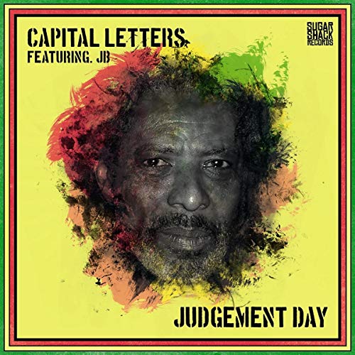 Album cover with a man's face surrounded by red, green, and orange paint splatters.