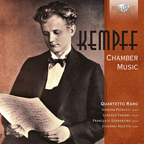 The image is a CD cover featuring a man in a tuxedo holding sheet music. alt text: Man in tuxedo holding sheet music, with text on an orange background.