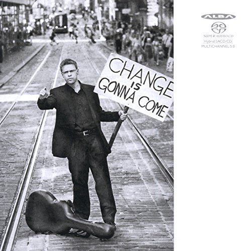 Black and white album cover with a man holding a protest sign and guitar case.