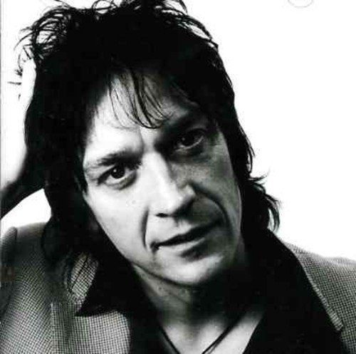 Black and white portrait of a man with long, dark hair.