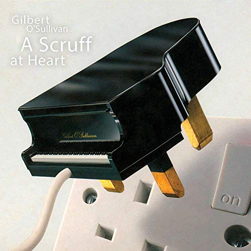 "Piano shaped like an electrical plug, plugged into a white wall socket."