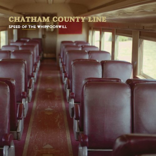 Album cover: rows of red seats inside a vintage train car.