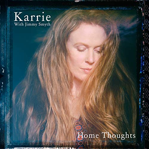 CD album cover featuring a woman with long hair against a dark background.