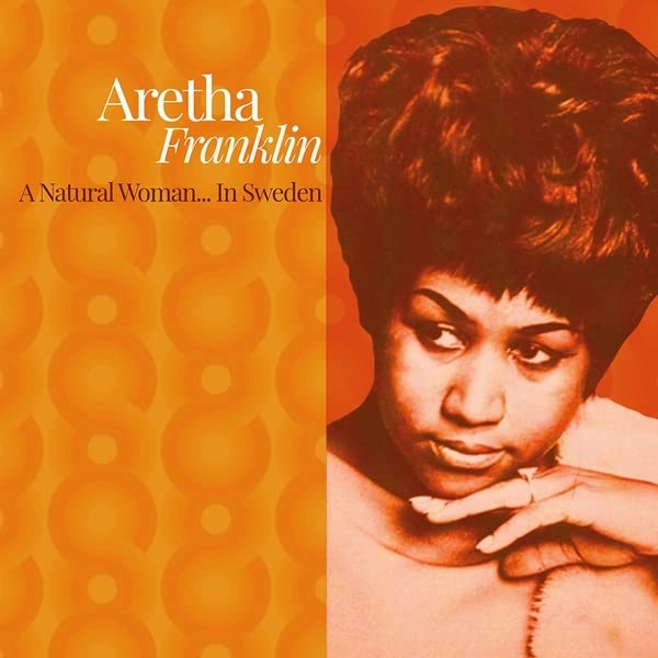 Aretha Franklin portrait on an orange album cover with circular patterns.