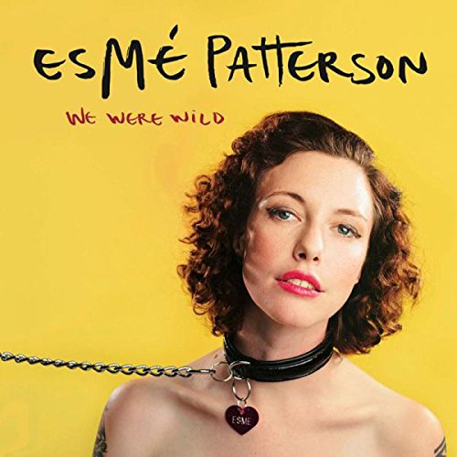 The image depicts a vinyl record cover featuring a woman against a yellow background.