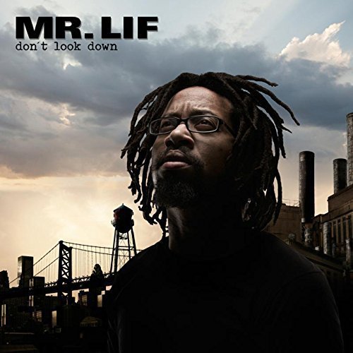 "Album cover featuring a man with dreadlocks against an industrial cityscape background."