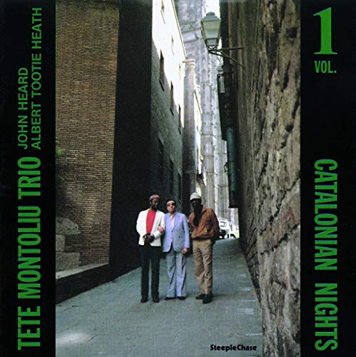 Album cover: jazz trio standing in a narrow European street.