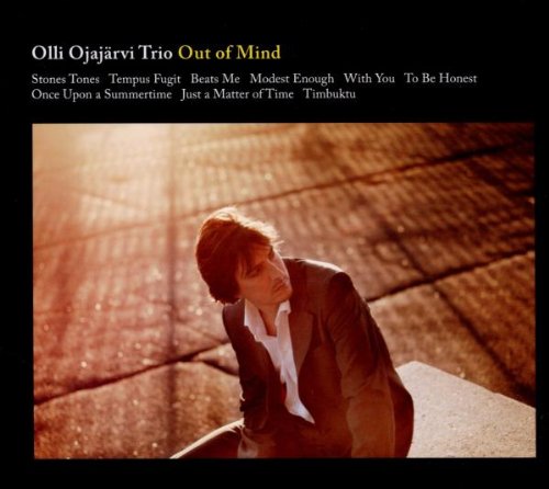 "CD cover with a man crouching on a tiled floor, black background, artist and song titles."